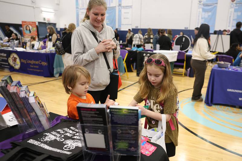 Melissa Jilek visits the Enchanted Castle table with her tow children Tyler, 5, and Karianne, 7, during the Will County’s annual Kids Fair at Troy Middle School on Monday, Feb. 16, 2026 in Joliet.