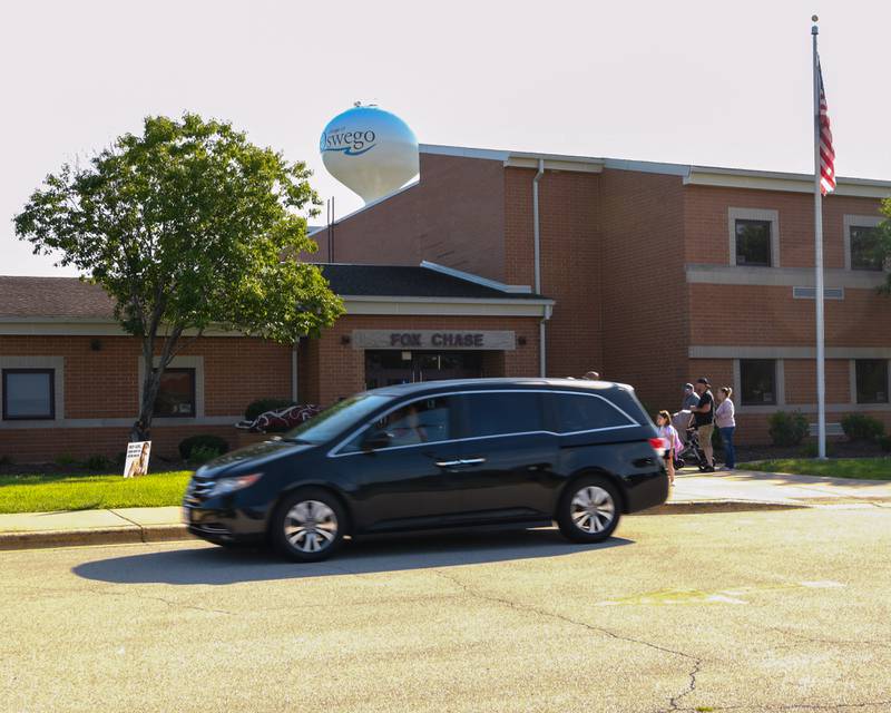 Students get dropped off outside of Fox Chase Elementary in Oswego on Wednesday Aug. 16, 2023, during the first day of class.