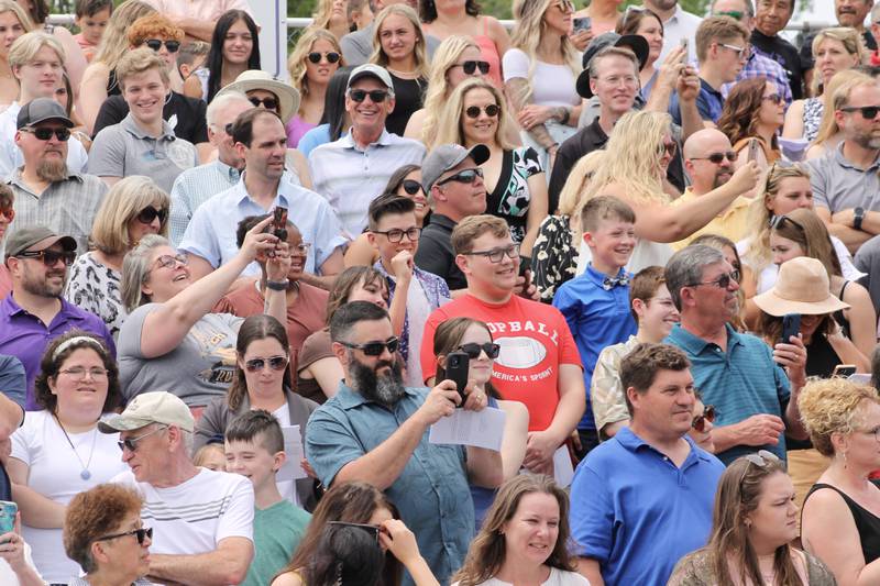 Members of the crowd for the Dixon High School Class of 2023 graduation take pictures as the processional leads past the stadium seats on Sunday, May 28, 2023.