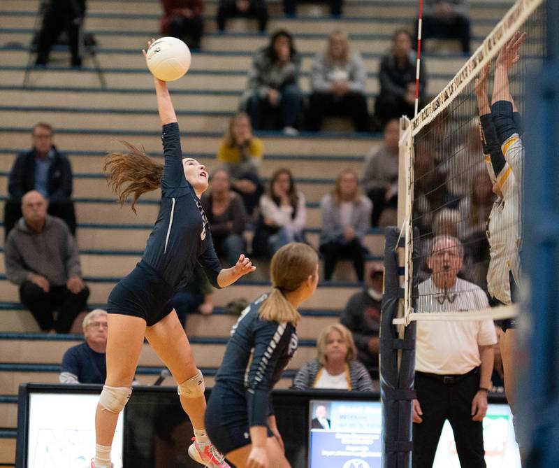 Oswego East's Samantha Trujillo (6) goes up for a kill against Neuqua Valley during the Neuqua Valley 4A regional final volleyball match at Neuqua Valley High School in Naperville on Thursday, Oct 27, 2022.