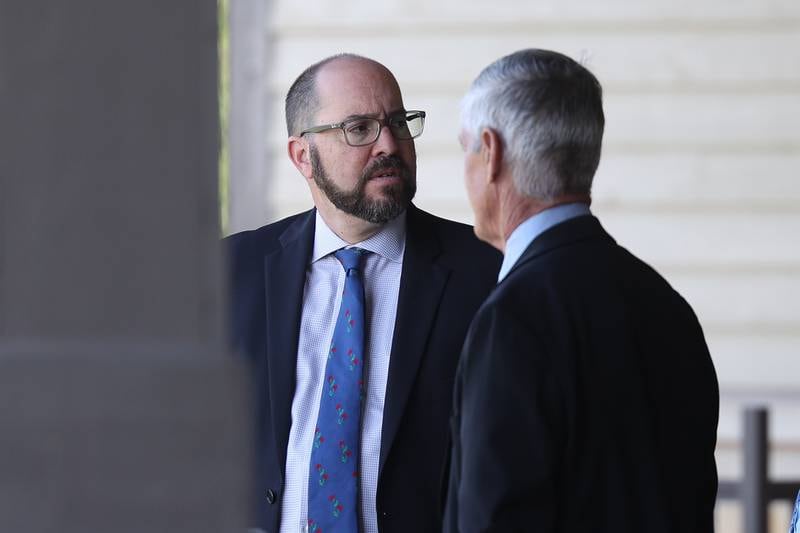 David Berault waits outside for the start of Illinois Health Facilities and Services Review State Board Meeting on Thursday, July 27 in Bolingbrook.