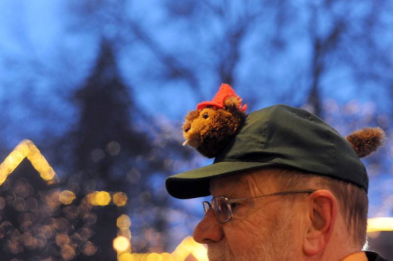 Groundhog Days Committee Chairman Rick Bellairs sports a groundhog themed cap  Wednesday, Feb, 2, 2022, during the annual Groundhog Day Prognostication on the Woodstock Square.