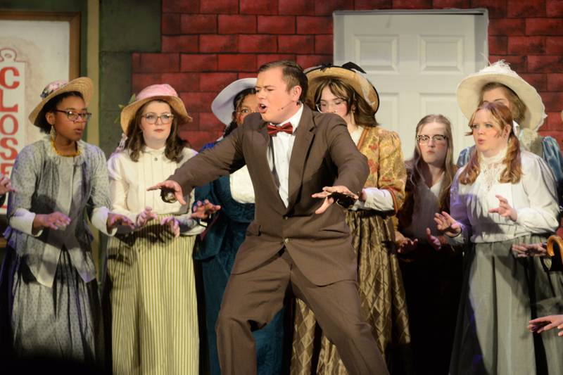 Harold Hill, portrayed by Logan Sarver, revs up the crowd during Oregon High School's performance of "The Music Man" on Thursday, March 7, 2024.