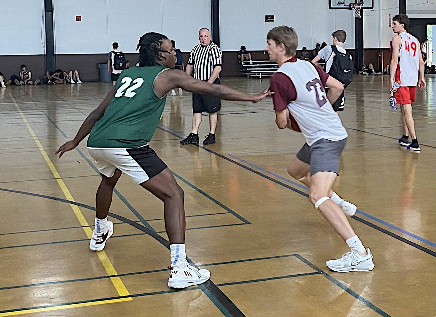 Morris' Jack Wheeler (right) looks for room to drive Tuesday in a game against Waubonsie Valley in the Morris Shootout.