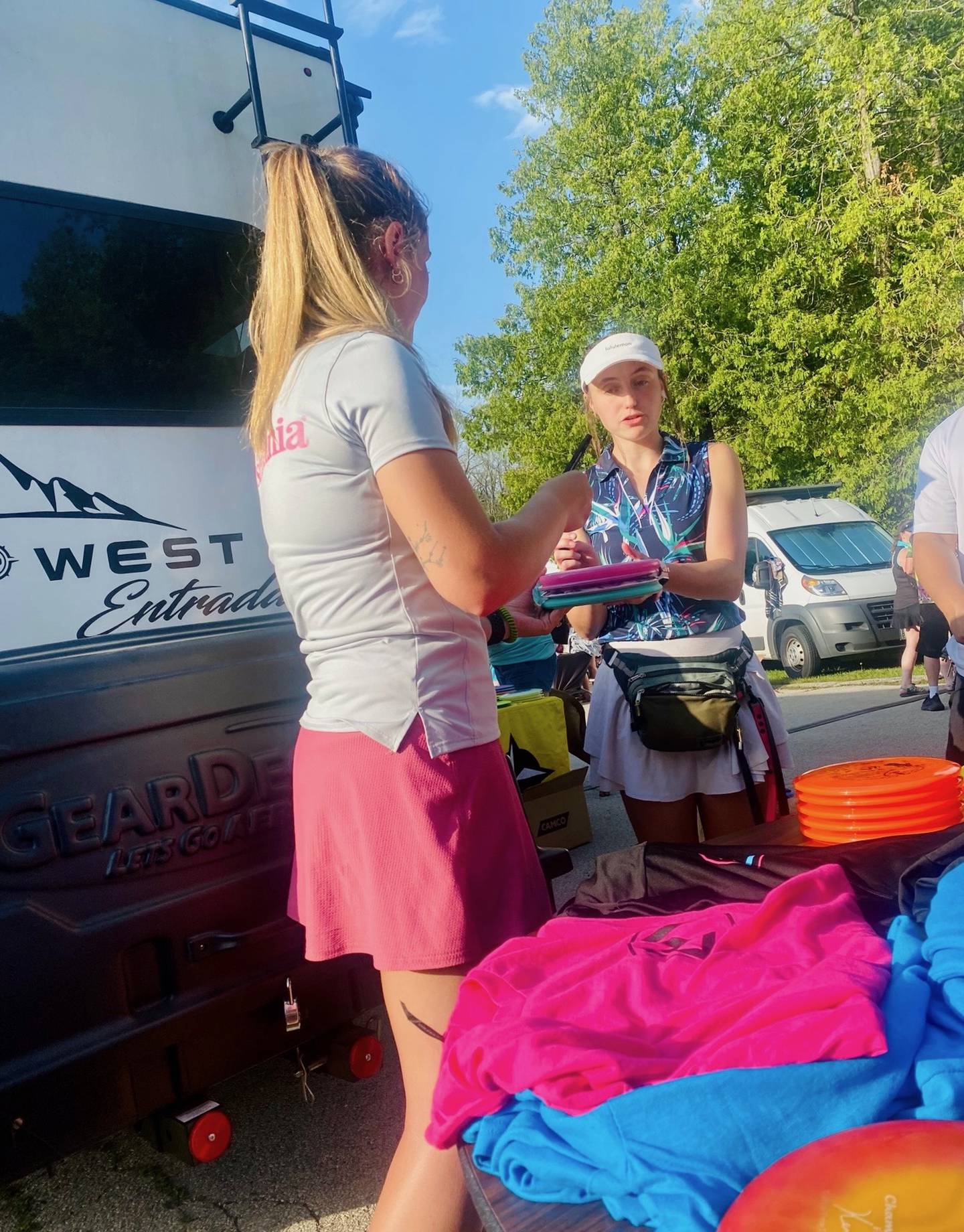 Lexi Marx signs an autograph for a fan. Marx plays in the Professional Disc Golf Association.