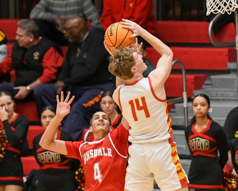 Batavia's Brett Berggren (14) makes a basket after getting a rebound and fouled by Hinsdale Central's Blaze Burt (4) during the game on Saturday Jan. 24, 2026, held at Batavia High School.