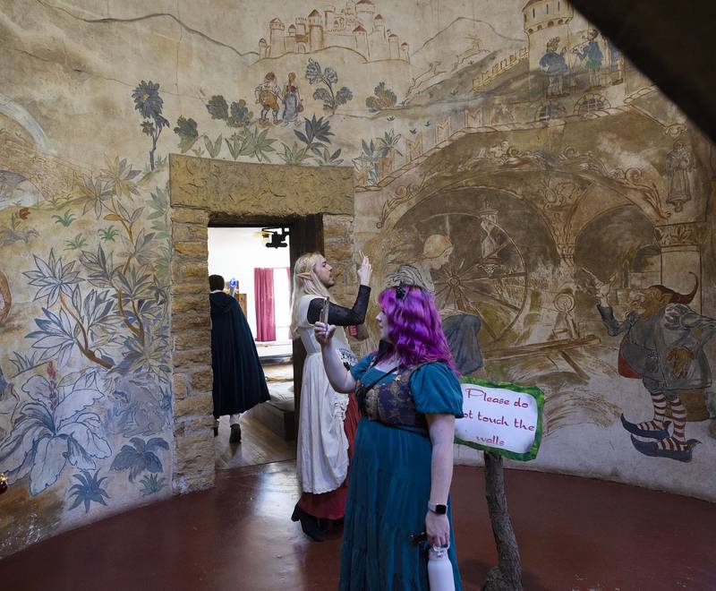 Visitors take pictures of the paintings inside of the Stronghold tower Sunday, October 5, 2025, in Oregon.