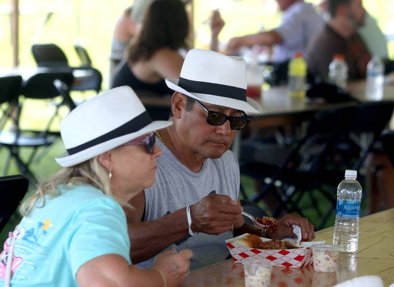 Gabe and Dee Gutierrez of Melrose Park sample some food during the final day of Bands, Brews, and BBQ at McHenry’s Petersen Park Sunday.