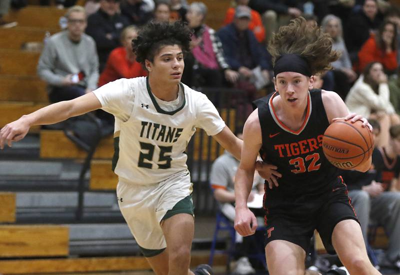 Crystal Lake Central's Luke Spychala drives to the basket against Boylan’s Santana English during a IHSA Class 3A boys basketball regional boys basketball game Thursday, Feb. 23, 2023, at Woodstock High School.
