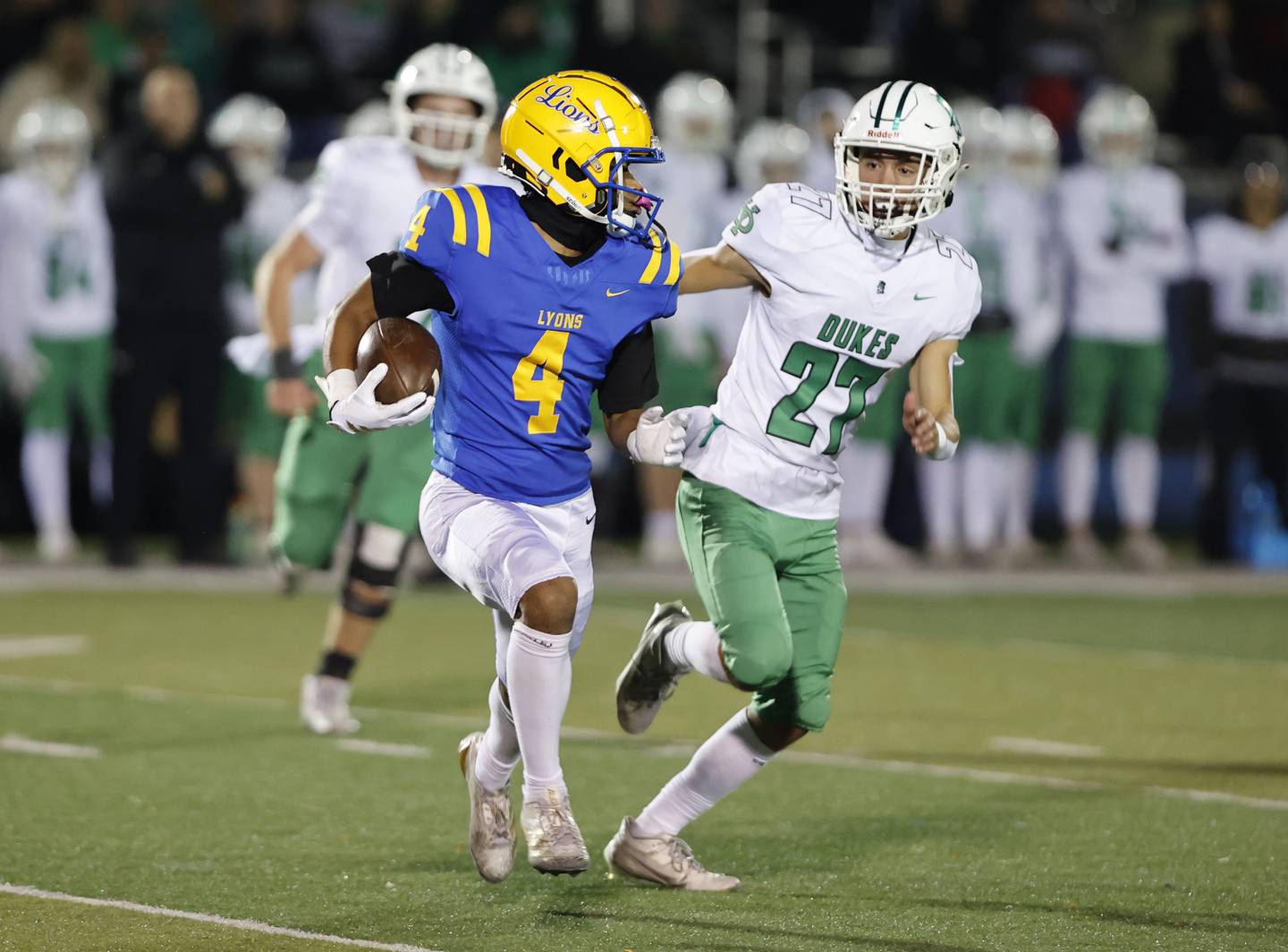 Lyons' Anthony Pearson (4) runs the ball during the varsity football first-round 8A playoff game between York and Lyons Township on Friday, Oct. 31, 2025 in Western Springs, IL.