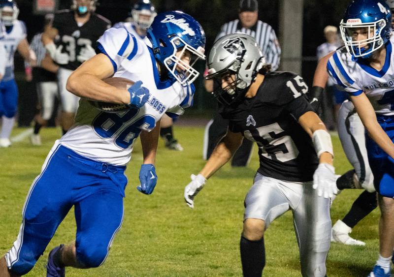 Riverside Brookfield's Luke Kumskis (86) runs after the catch against Kaneland’s Alexander Panico (15) during a 6A playoff football game at Kaneland High School in Maple Park on Friday, Oct 28, 2022.