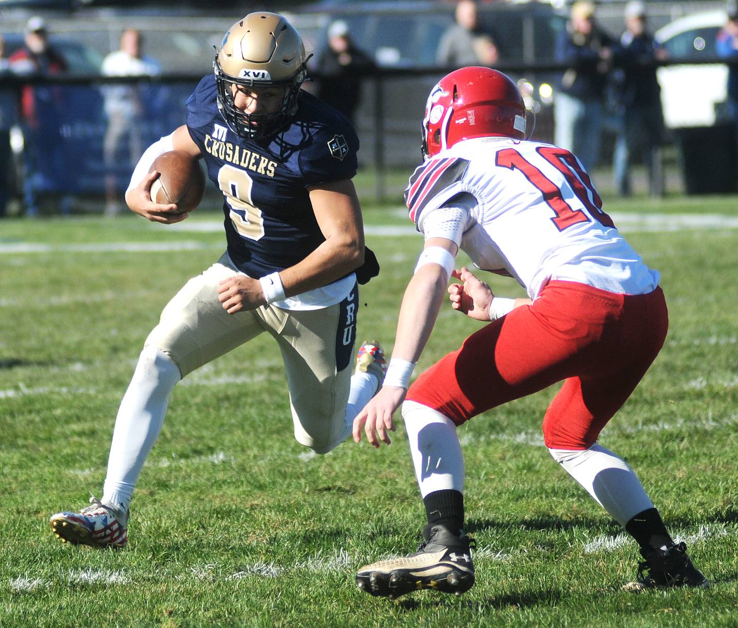 Marquette quarterback Alex Graham (9) tries to outrun Fulton's Connor Sheridan at Gould Stadium on Saturday, Nov. 6, 2021.