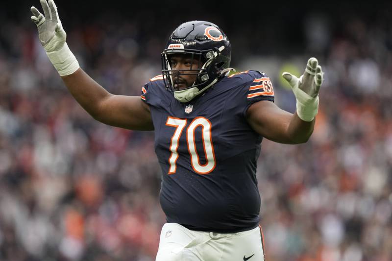 Chicago Bears offensive tackle Braxton Jones (70) celebrates after a touchdown against the Jacksonville Jaguars during an NFL football game at Tottenham Hotspur Stadium, Sunday, Oct. 13, 2024 in London. (AP Photo/Steve Luciano)