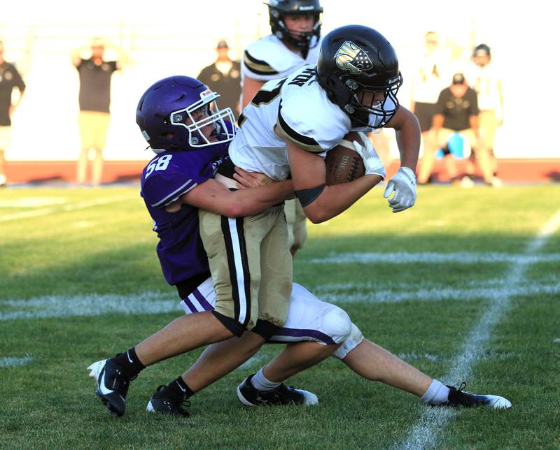 Rochelle's Levi McGee (58) tackles a Lena-Winslow player during their JV football game on Friday, Sept. 12, 2025.