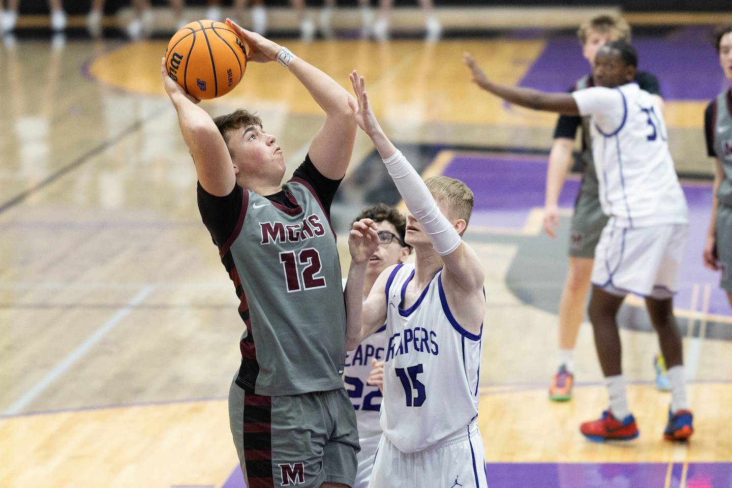 Marengo's Sam Vandello (12) looks to put up a shot over Plano's Logan Martin (15) during Wednesday's game in Plano.