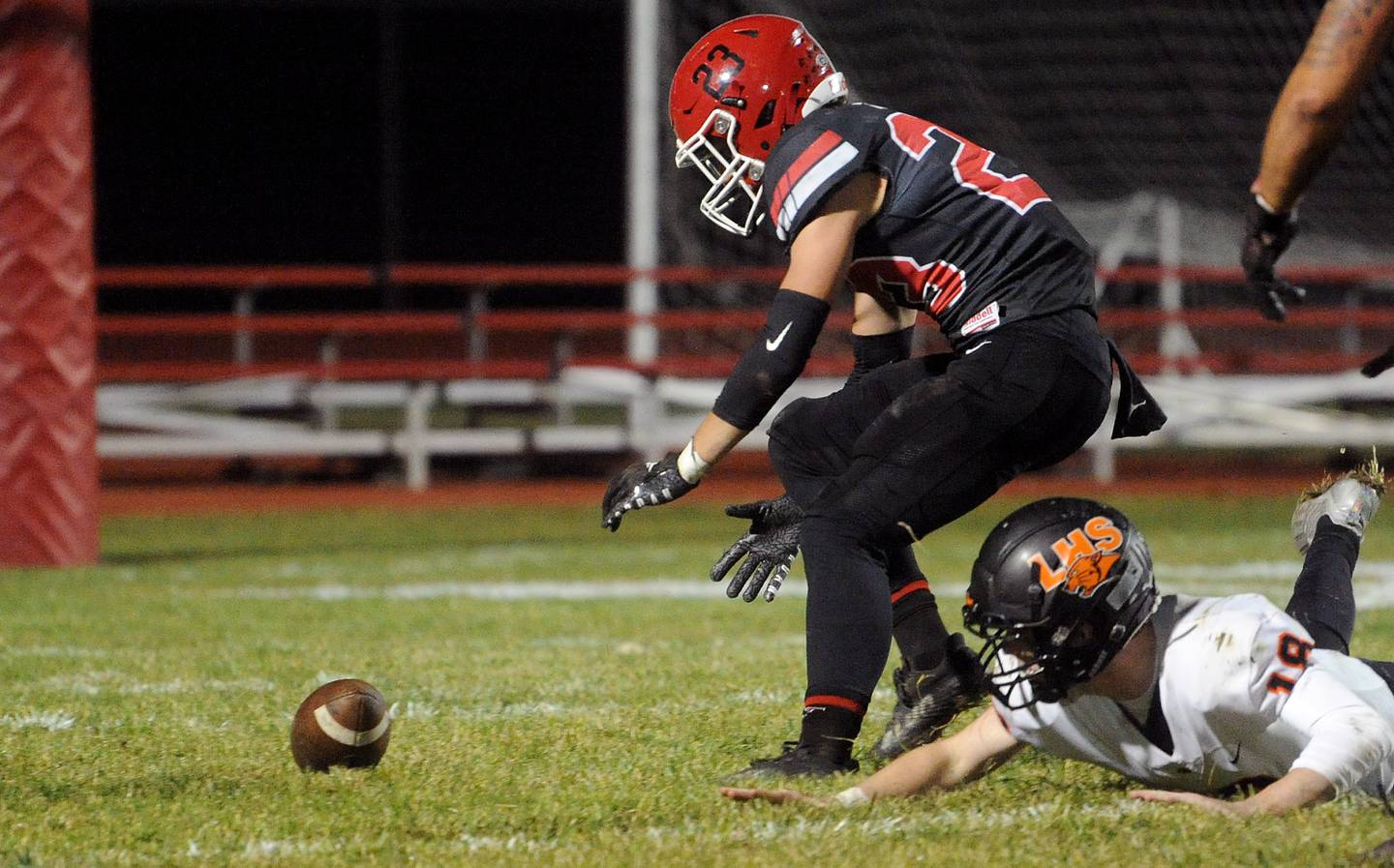 Yorkville's Luke Zook (23) recovers a blocked punt by Libertyville kicker Quinn Schambow (18) and scores a touchdown during a class 7A playoff football game at Yorkville High School on Friday, Oct. 28, 2022.