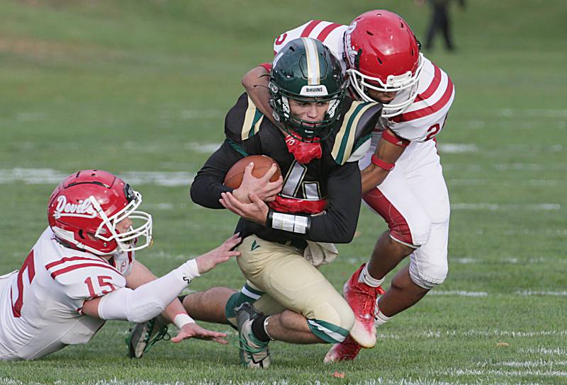 St. Bede's quarterback John Brady (4) is taken down by Hall's Joel Rangel (24) and teammate Tristan Redcliff (15) on Saturday, Oct. 15, 2022 at the Academy in Peru.