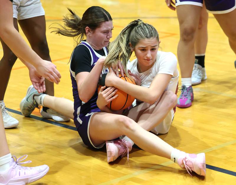 Genoa-Kingston's Presley Meyer (right) and Rochelle's Jaydin Dickey fight for a loose ball during their game Monday, Dec. 16, 2024, at Genoa-Kingston High School.