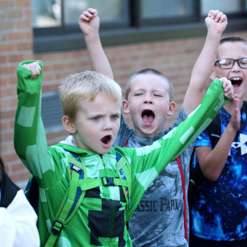 Lincoln Elementary School second graders give a cheer to show how excited they are to arrive for the first day of classes Wednesday, Aug. 14, 2024, at the school in DeKalb.