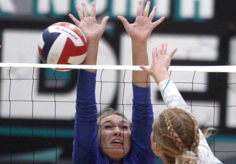 Woodstock’s Kennedy Cordell blocks in varsity volleyball at Woodstock North Monday night.
