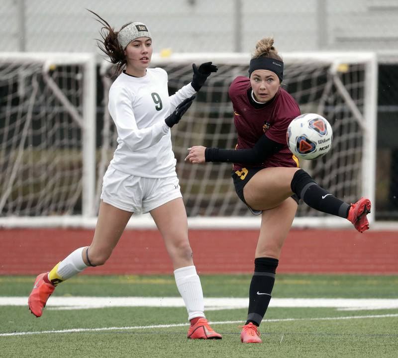 Crystal Lake South's Elise Gorman, left, tries to pressure Schaumburg's Jessica Beymer during girls soccer action Saturday, March 26, 2022 in Schaumburg.