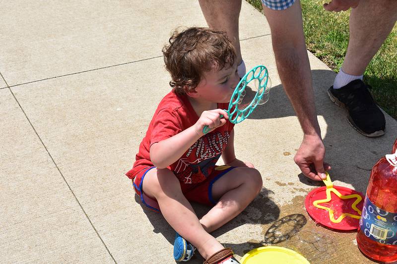 Asher Arnold, 2, of Byron blows bubbles during Summer Splash Saturday, June 21st, 2025.