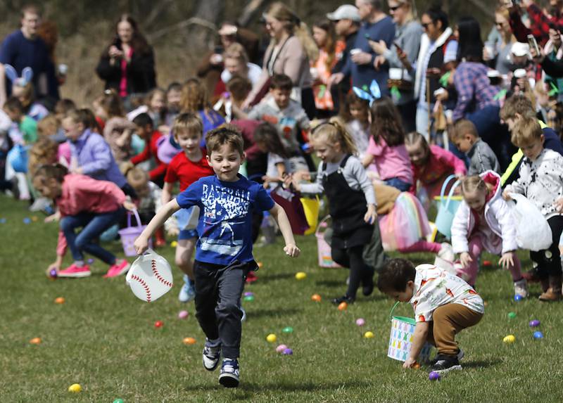 Children run to grabs eggs on Saturday, April 19, 2025, during the Johnsburg Easter Egg Hunt at Sunnyside Memorial Park, in Johnsburg. Children hunted for 6,000 candy-filled eggs in three hunts divided by age group.