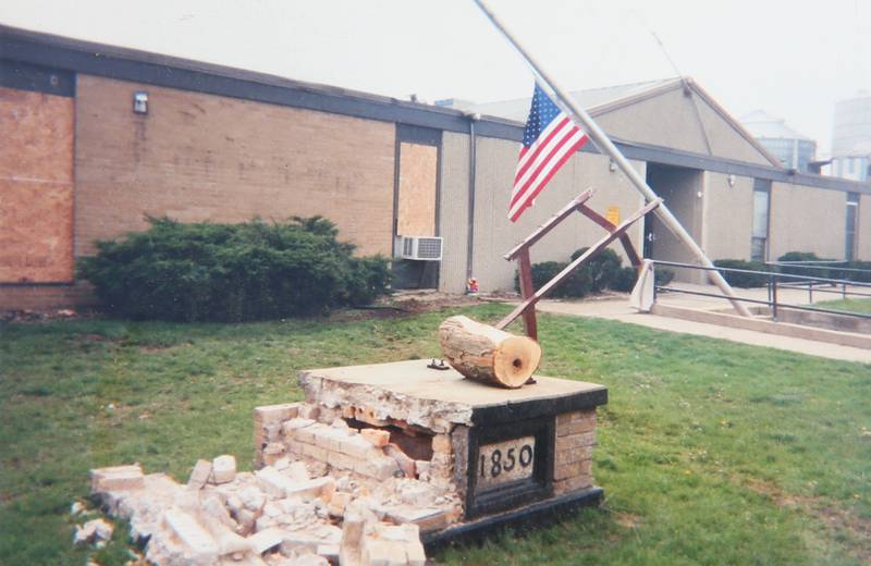 Damage to the flagpole base at the former Utica Grade School building from the tornado on Wednesday, April 21, 2004 in Utica.