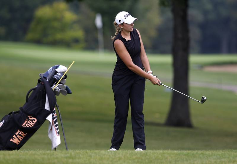 McHenry’s Madison Donovan watches her tee shot on the chips on to the 14th green during the Fox Valley Conference Girls Golf Tournament Wednesday, Sept. 20, 2023, at Crystal Woods Golf Club in Woodstock.