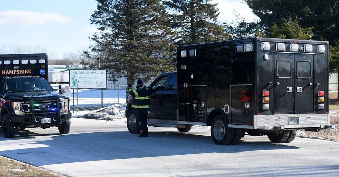 A Kane County coroner van enters the W.R. Meadows complex in Hampshire Friday, Jan. 21, 2022, after one person was killed in a building explosion.