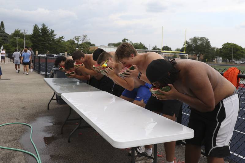 Participants take part in the Watermelon Race during the West Aurora "Battle of the Butts" Lineman Challenge, July 10, 2025  in Aurora.