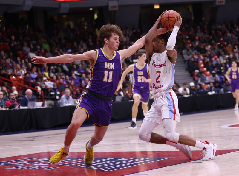Kenwood Academy's Tyler Smith (2) tries to get past Downers Grove North's Owen Thulin (11) during the boys 4A super-sectional game between Kenwood Academy and Downers Grove North high school in Chicago on Monday, March 6, 2023.
