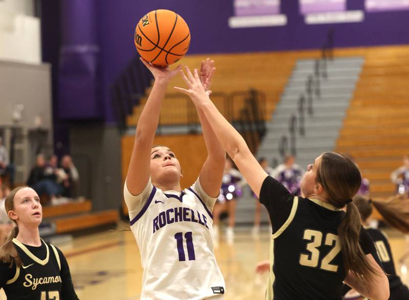 Rochelle's Audrina Rodriguez shoots over Sycamore's Quinn Carrier Friday, Dec. 5, 2025, during their game at Rochelle High School.