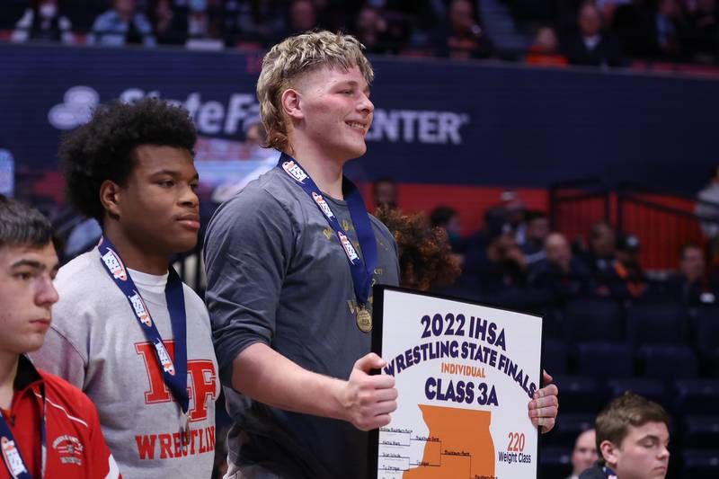 Lockport’s Andrew Blackburn-Forst takes the podium as the Class 3A 220lb. champion at State Farm Center in Champaign. Saturday, Feb. 19, 2022, in Champaign.