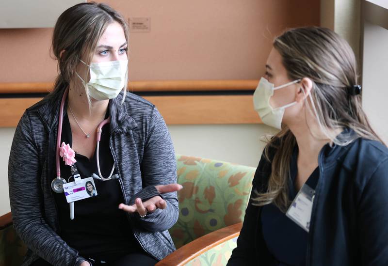 Travel nurses Alexandra Pop (left) and Taylor Zarris talk about the benefits and difficulties involved in being a travel nurse Wednesday, March 23, 2022, at Northwestern Medicine Kishwaukee Hospital in DeKalb.