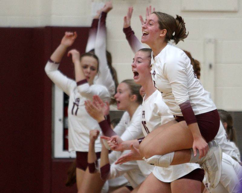 Prairie Ridge’s Grace Jansen, front, and the Wolves get excited in a win over Hampshire during varsity volleyball on Thursday, Oct. 3, 2024, at Prairie Ridge High School in Crystal Lake.