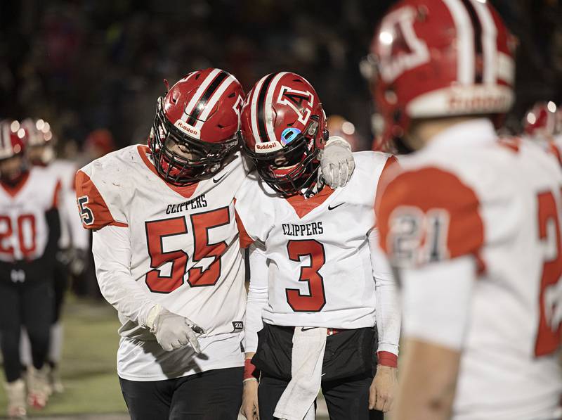 Amboy’s Landon Montavon (left) and Tucker Lindenmeyer walk off the field after a tough 44-36 loss to West Central in the 8-man championship game Friday, Nov. 18, 2022.