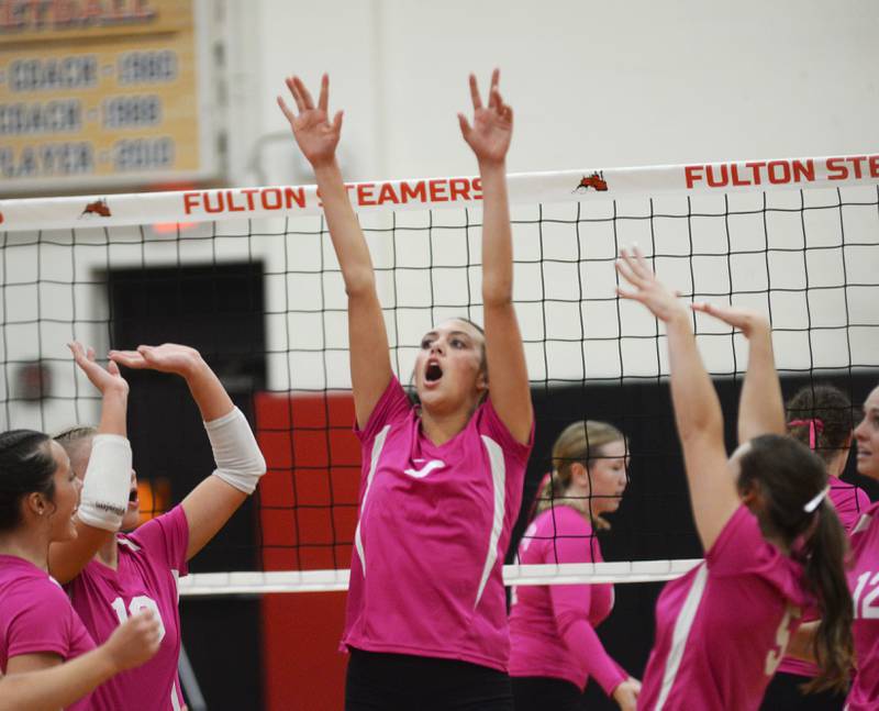 Fulton's Chloe Wilkin (center) celebrates a point over Eastland with her teammates on Tuesday, Oct. 7, 2025 in Fulton.