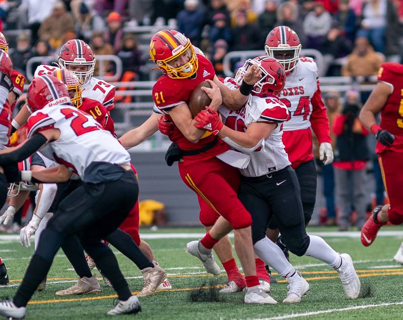 Batavia’s Ryan Boe (21) carries the ball on a keeper and hit by Yorkville's Blake Kersting (40) during a 7A quarterfinal playoff football game at Batavia High School on Saturday, Nov 12, 2022.