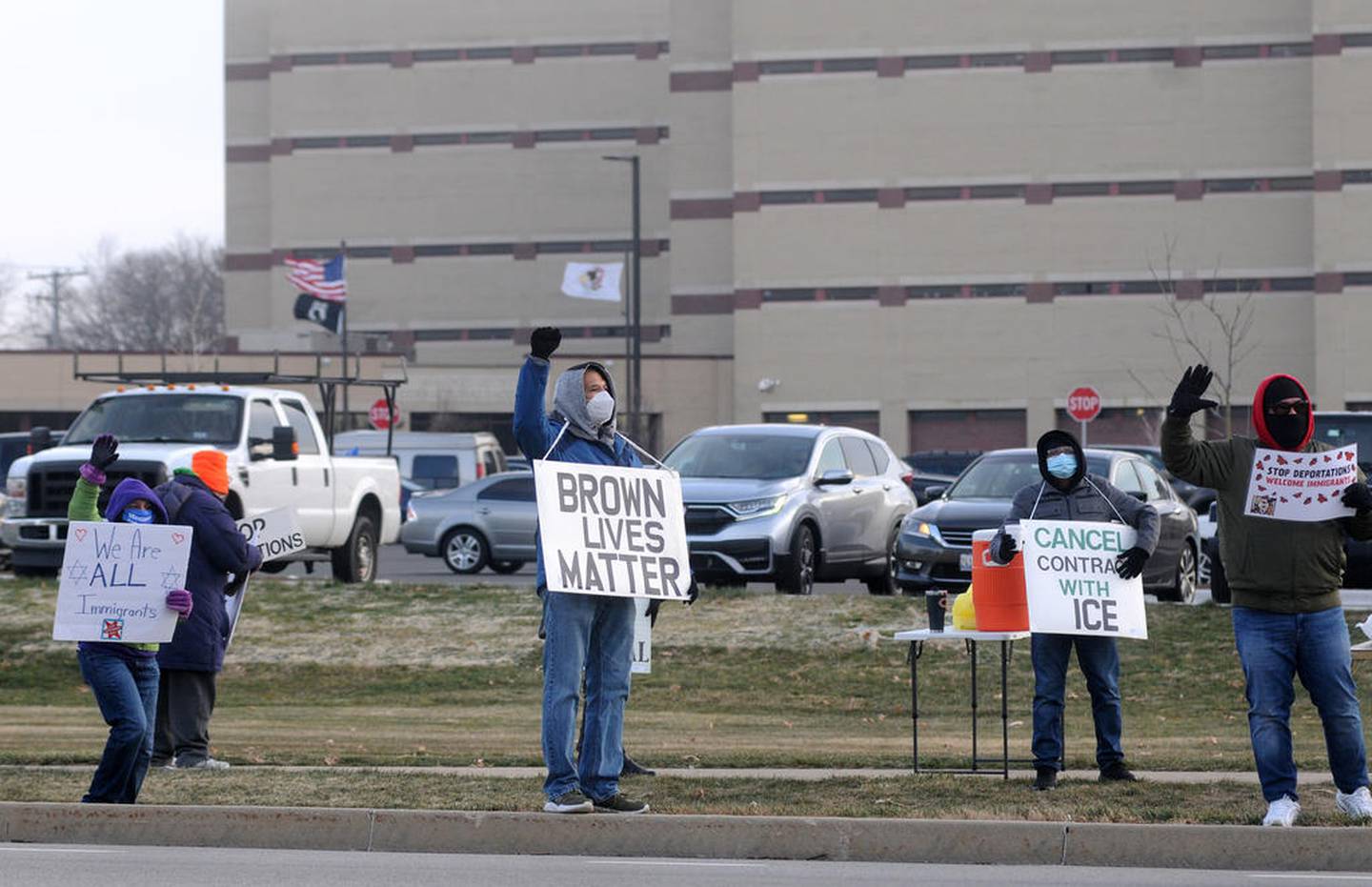 Protesters hold up signs the morning of Thursday, Dec. 3, 2020, during a rally aimed at persuading the McHenry County Board to cancel its contract with the U.S. Immigration Customs and Enforcement to detain immigrants in the McHenry County Jail. About 25 to 30 people protested outside the facility at 2200 N. Seminary Ave. in Woodstock.