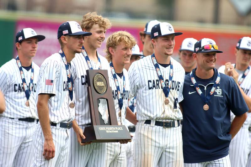 Cary-Grove’s Trojans stand with their trophy after falling to Triad in IHSA Class 3A Third Place Game baseball action at Slammer Stadium in Joliet on Saturday, June 14, 2025.