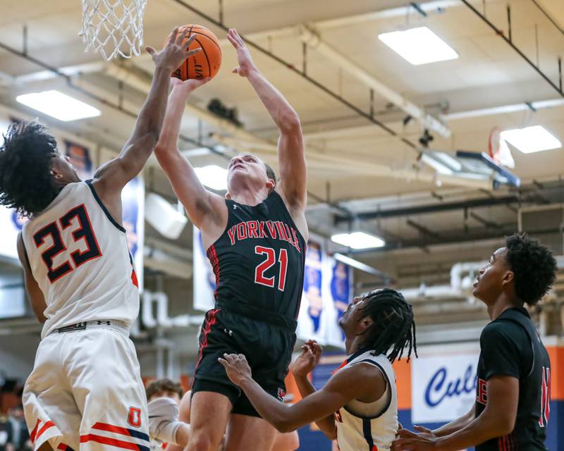 Yorkville's Taelor Clements (21) goes back up after grabbing a rebound during their basketball game between Yorkville at Oswego, Tuesday Dec 10, 2024 in Oswego.
