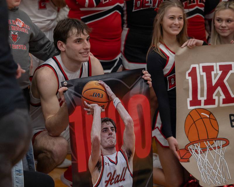 Braden Curran (33) of Hall holds sign honoring his 1,000th career point on Saturday, January 31, 2026 at Hall High School in Spring Valley.