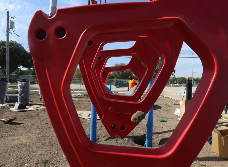 A worker from Build LLC Custom Playgrounds constructs a ninja obstacle course located south of the splash pad on Thursday, Oct. 2, 2025 in Washington Park in Peru. The city will also be installing ice rink chillers soon for the upcoming winter season.