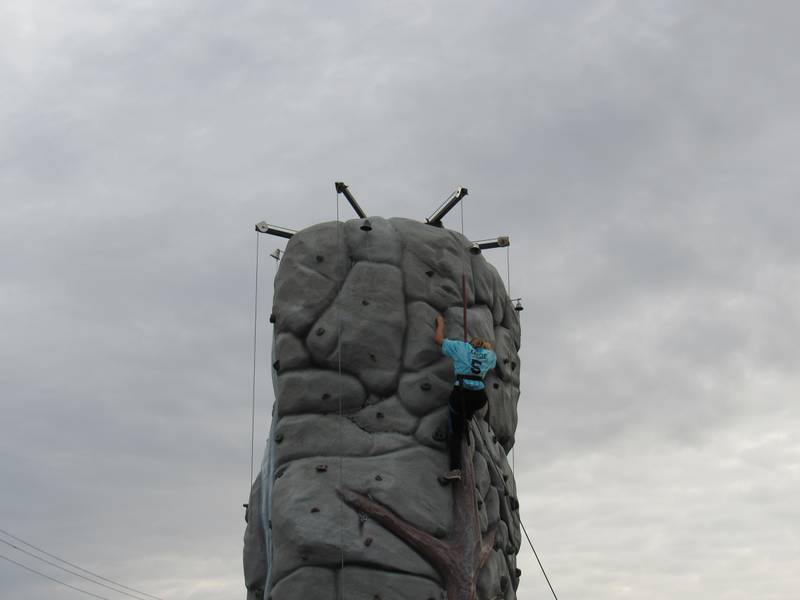 10-year-old Rileigh rings the bell on the rock climbing wall at the Coal City Fall Festival.