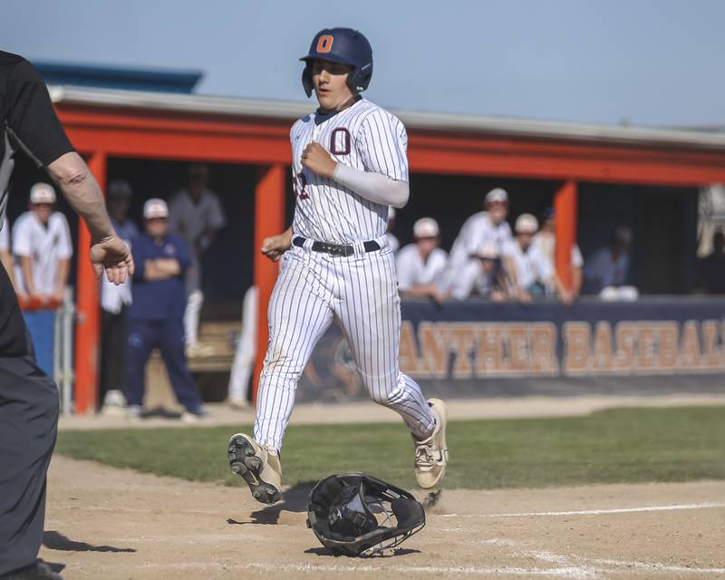 Oswego's Dylan Doogs (12) scores a run during baseball game Oswego East at Oswego.  May 14, 2026 in Oswego.