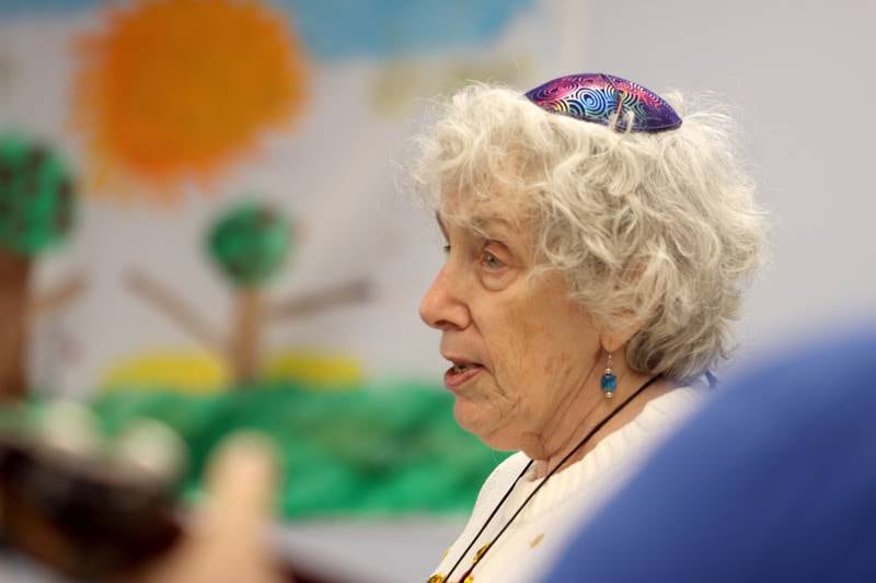 Rabbi Maralee Gordon leads the congregation in song during a Chanukah party at The McHenry County Jewish Congregation Sunday.
