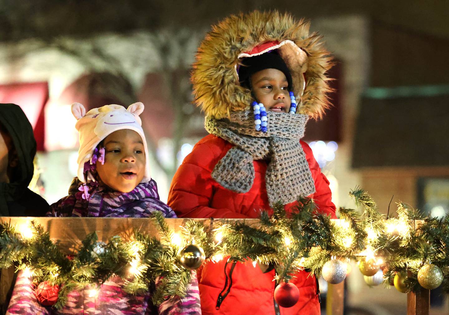 Eyanni Booker, (left) 3, and Faith Williams, 6, from DeKalb, sing carols as they wait for Santa at the Santa house near the Egyptian Theatre Thursday, Dec. 1, 2022, during the DeKalb Chamber of Commerce Lights on Lincoln and Santa Comes to Town.