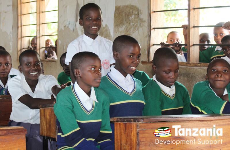 Students in the rural village of Nyegina, Tanzania, sharing their learning outcomes from the 4H Program supported by Tanzania Development Support.
