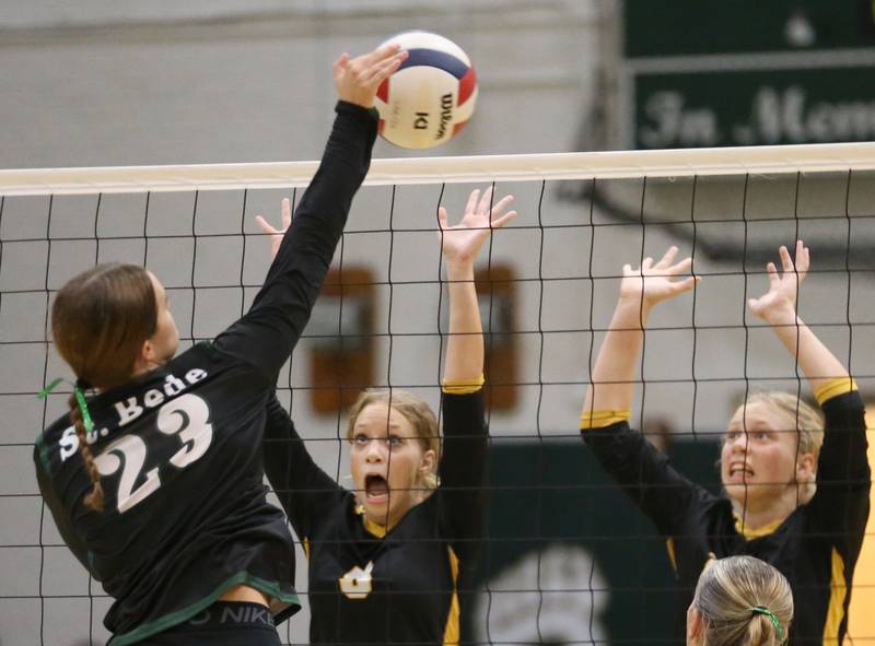 St. Bede's Mary Quinn McClain spikes the ball past Putnam Couunty's Cadence Coleman and teammate Kacie Coleman on Tuesday, Sept. 24, 2024 at St. Bede Academy.